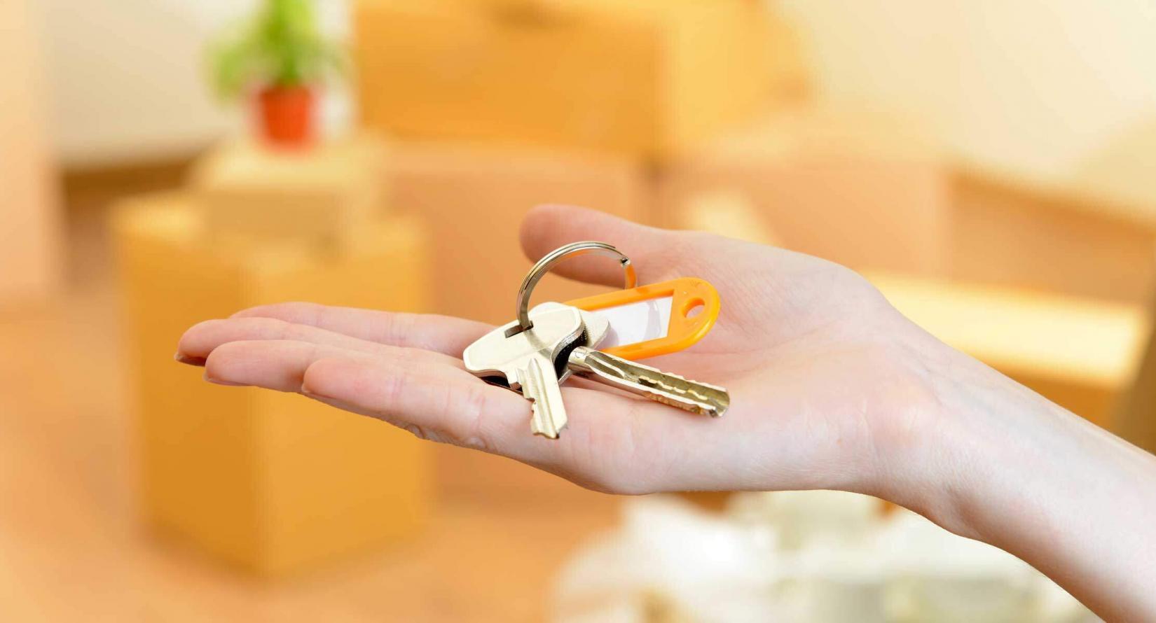 Hand holding set of keys to a new home