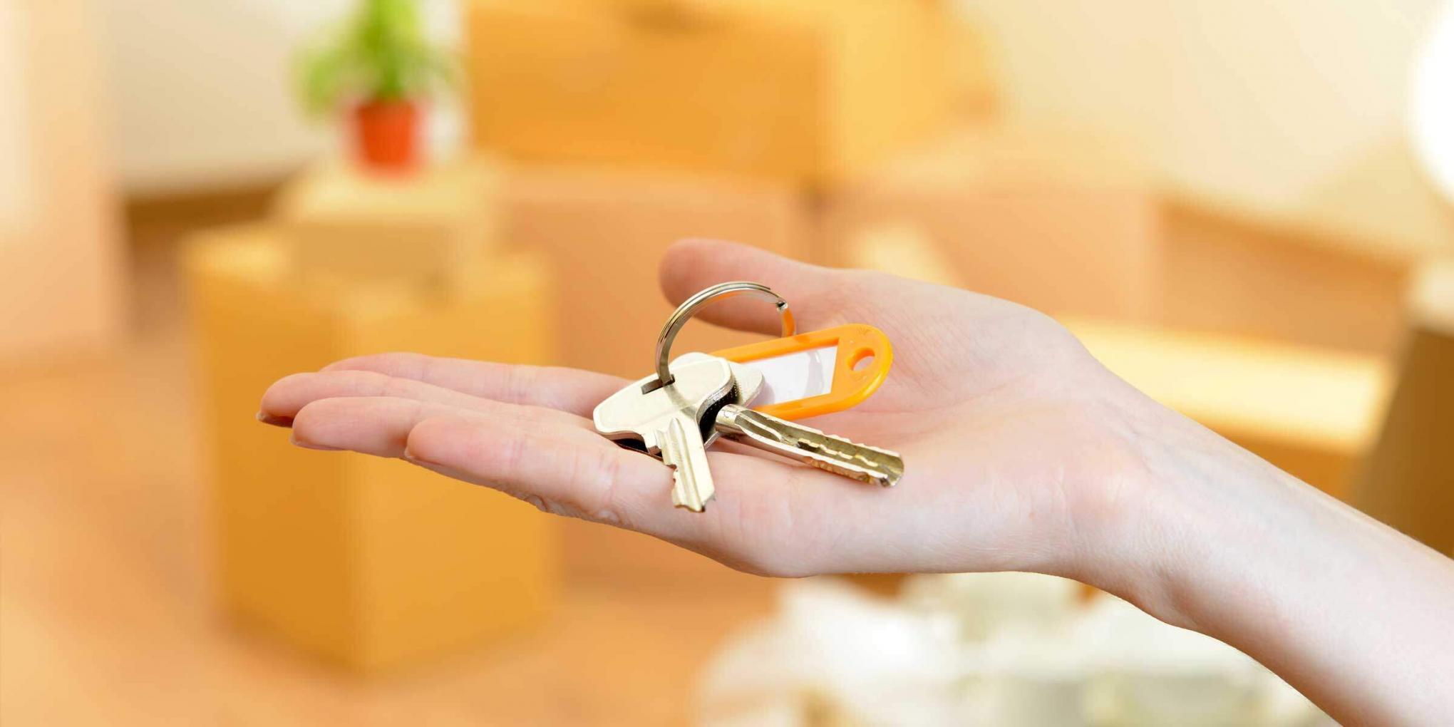 Hand holding set of keys to a new home